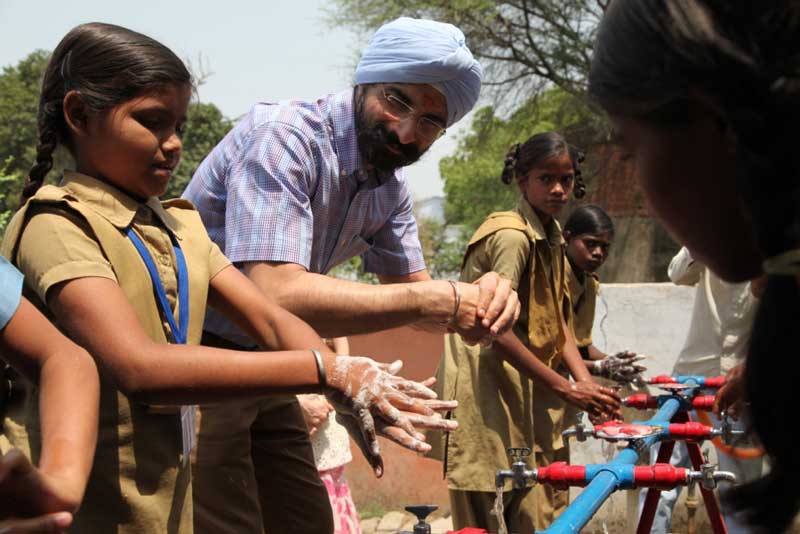Mr.-Harkirat-Singh,-Managing-Director,-Woodland-learning-hand-washing-from-school-children