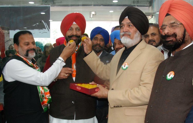 Col Ranjit Singh  Boparai, (retired)  offers ladoo, to  Balbir Singh Sidhu, former MLA and congress candidate from Mohali, at the inaguration of congress   election office at Phase V11 Market in Mohali on Tuesday.
