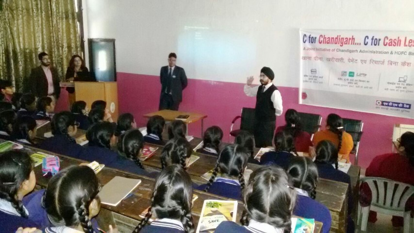 an-hdfc-bank-official-demonstrates-the-benefits-of-using-netbanking-mobile-banking-upi-ussd-and-mobile-apps-such-as-payzapp-and-chillr-at-a-school-in-chandigarh-small